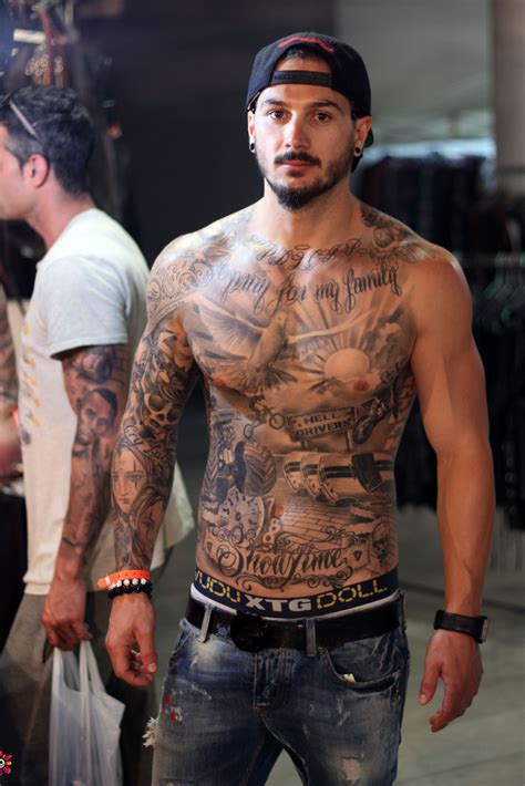 A Man With Lots Of Tattoos On His Chest A Man With Lots Of Tattoos On His Chest