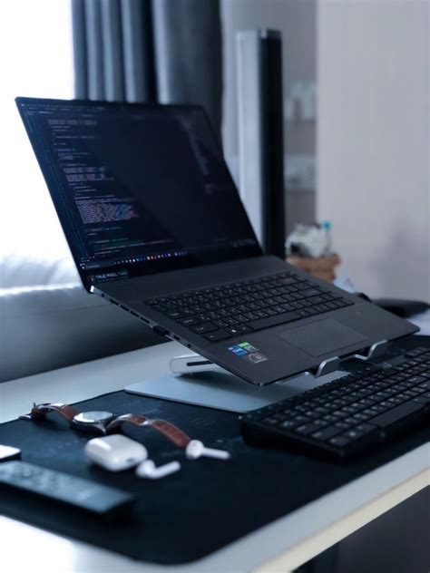 An Open Laptop Computer Sitting On Top Of A Desk Next To A Notebook And Pen