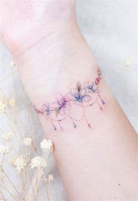 Cute Feminine Flower Armband Tattoo On Wrist Tattoo Designs For Women