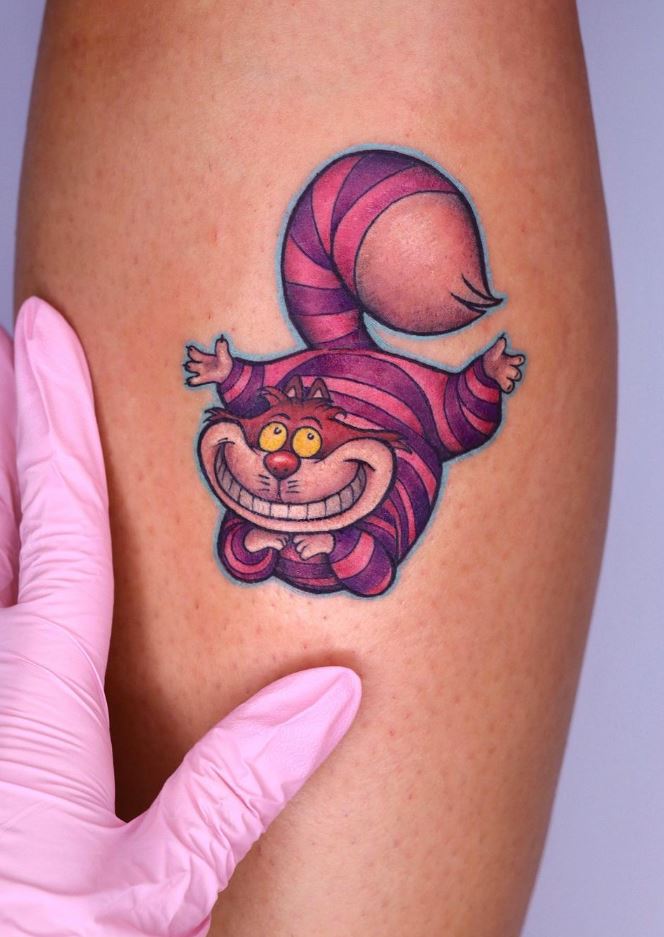 Impressive Multicolored Shoulder Tattoo Of Cheshire Cat Face