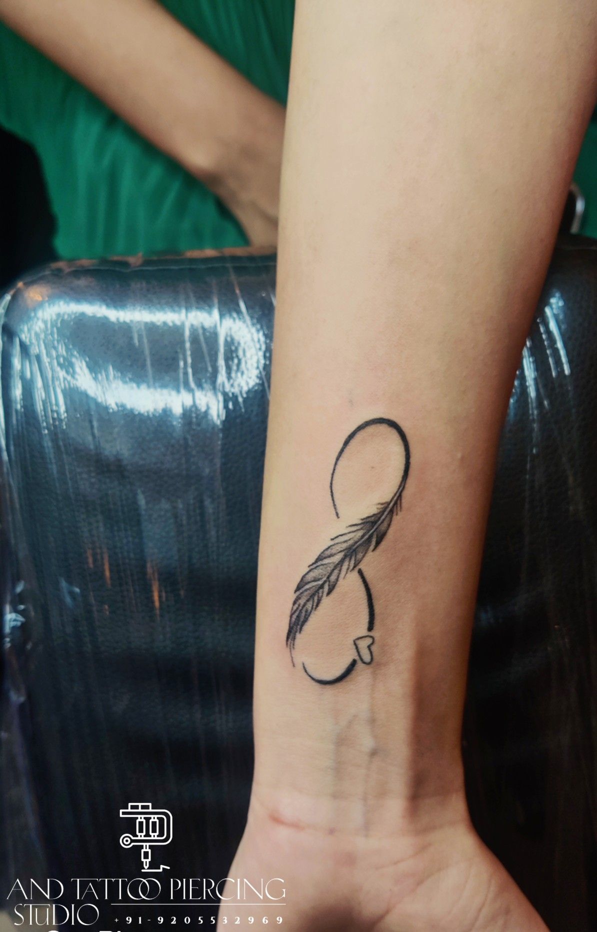 Infinity Feather Tattoo With Name On Wrist Done At Crazyink Tattoo